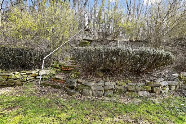 a view of a yard with wooden fence