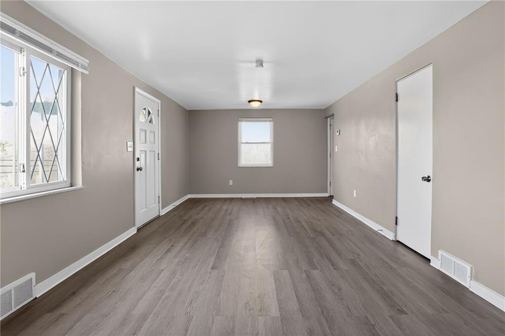 8030 Lincoln Road Verona, PA 15147 - Photo 4 of 34 an empty room with wooden floor and windows