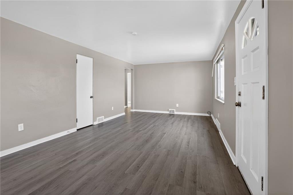 8030 Lincoln Road Verona, PA 15147 - Photo 7 of 34 an empty room with wooden floor and windows