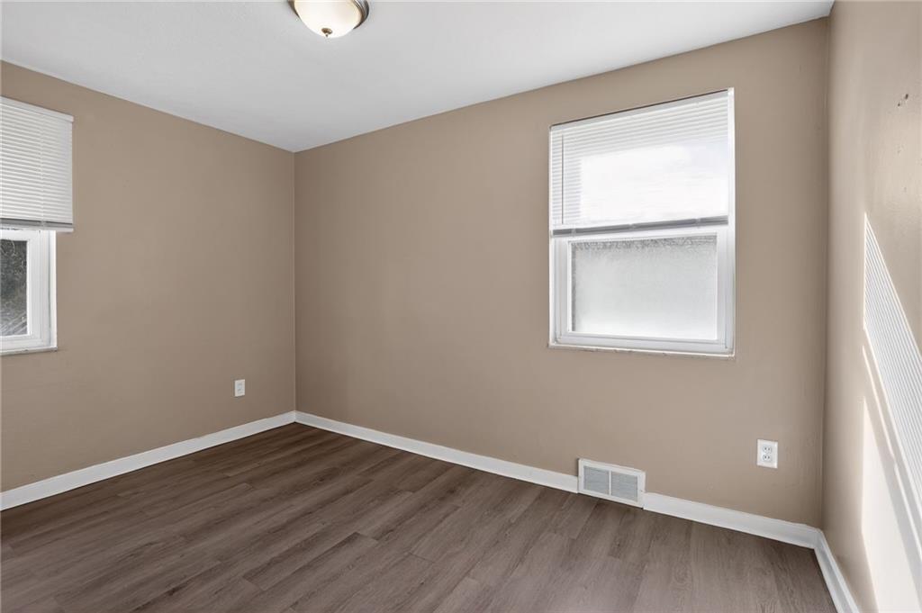8030 Lincoln Road Verona, PA 15147 - Photo 8 of 34 an empty room with wooden floor and windows