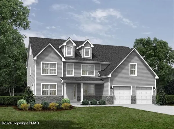 a front view of a house with a yard and green space