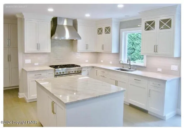 a kitchen with a sink stove and cabinets