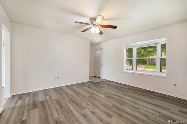 wooden floor in an empty room with a window