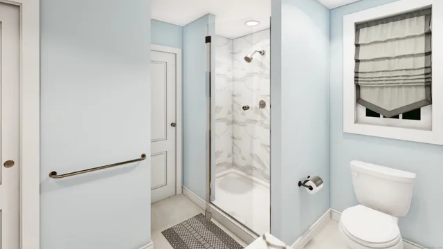 a bathroom with a toilet and a shower