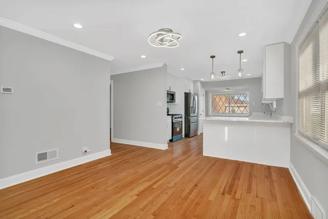 wooden floor fireplace and windows in an empty room
