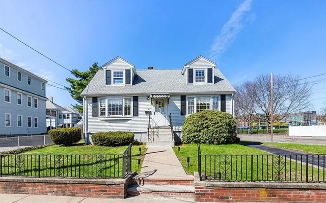 a front view of house with a garden