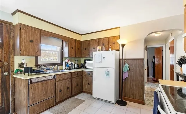 a kitchen with a refrigerator a sink and cabinets