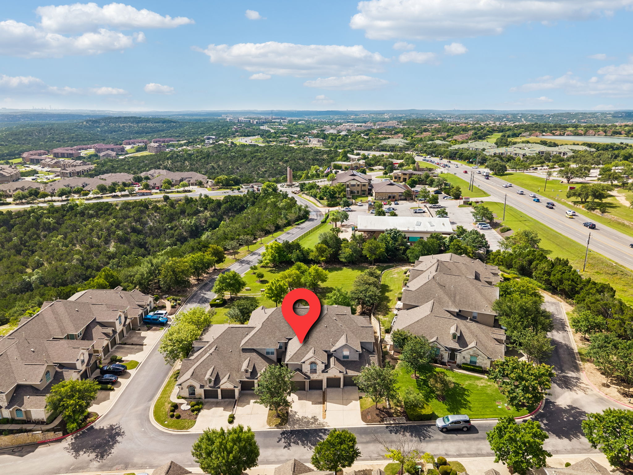 114 Aria Ridge, Unit 802 Lakeway, TX 78738 - Photo 35 of 37 An aerial perspective reveals a master-planned community nestled amongst rolling hills and verdant landscapes.