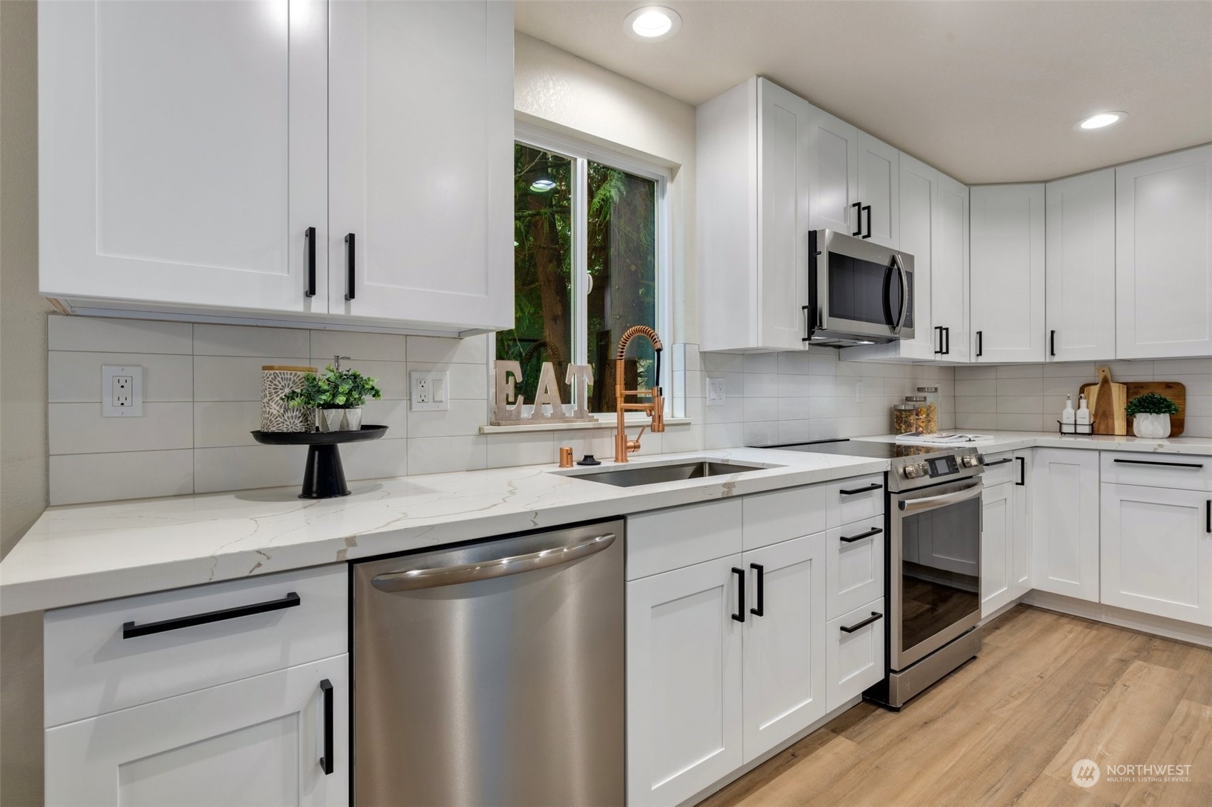 17728 28th Avenue Southeast Bothell, WA 98012 - Photo 18 of 40 a kitchen with stainless steel appliances granite countertop a sink a stove and cabinets