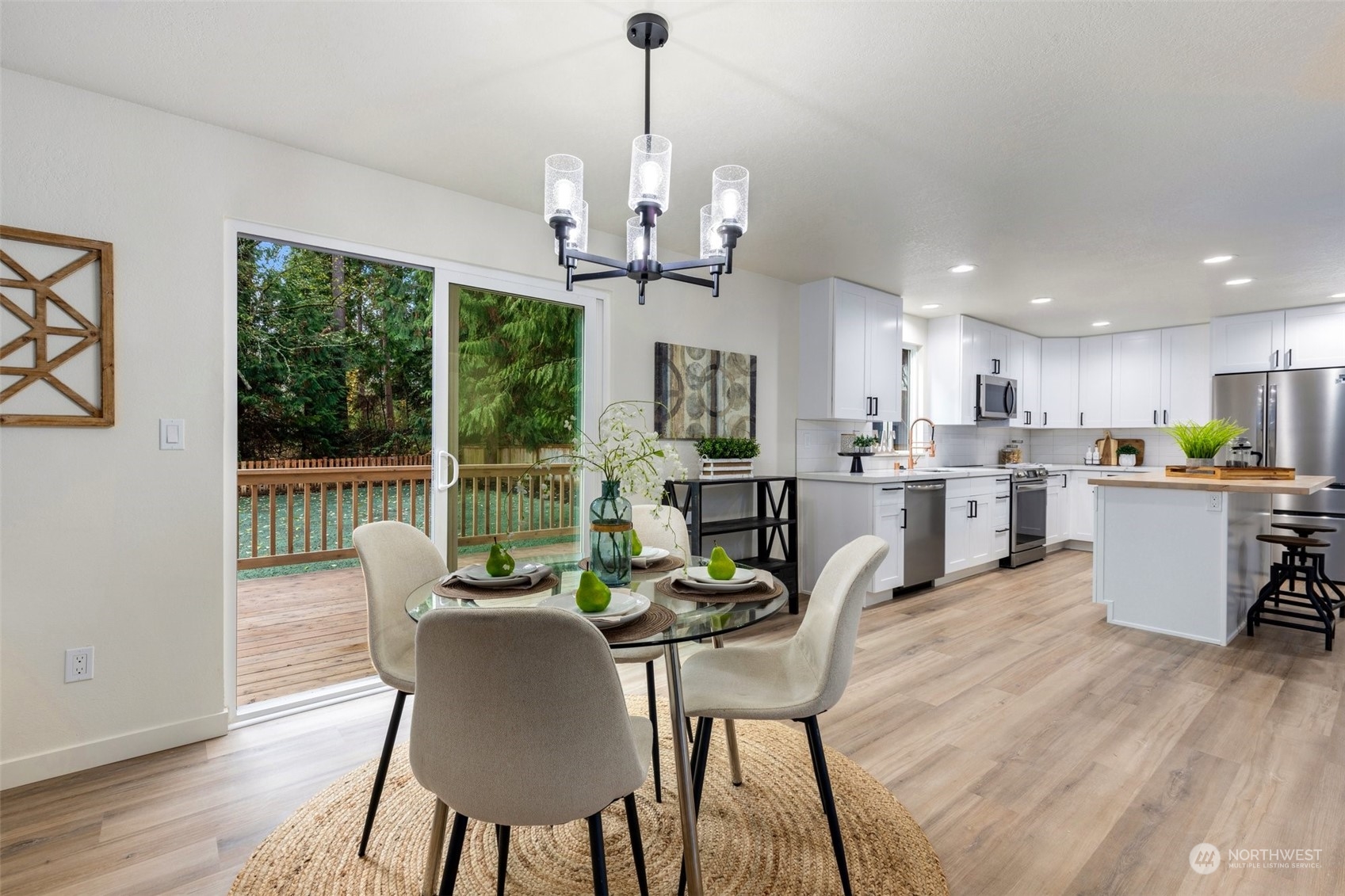 17728 28th Avenue Southeast Bothell, WA 98012 - Photo 19 of 40 a dining room with furniture a chandelier and wooden floor