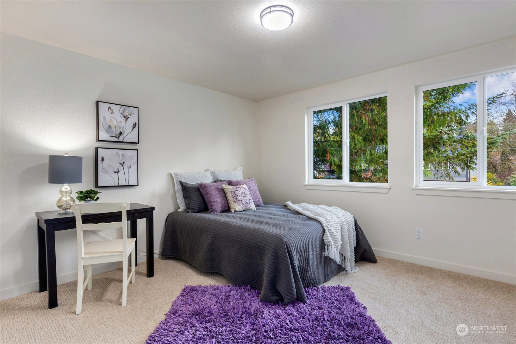 17728 28th Avenue Southeast Bothell, WA 98012 - Photo 30 of 40 a bedroom with a bed and a table in it with window