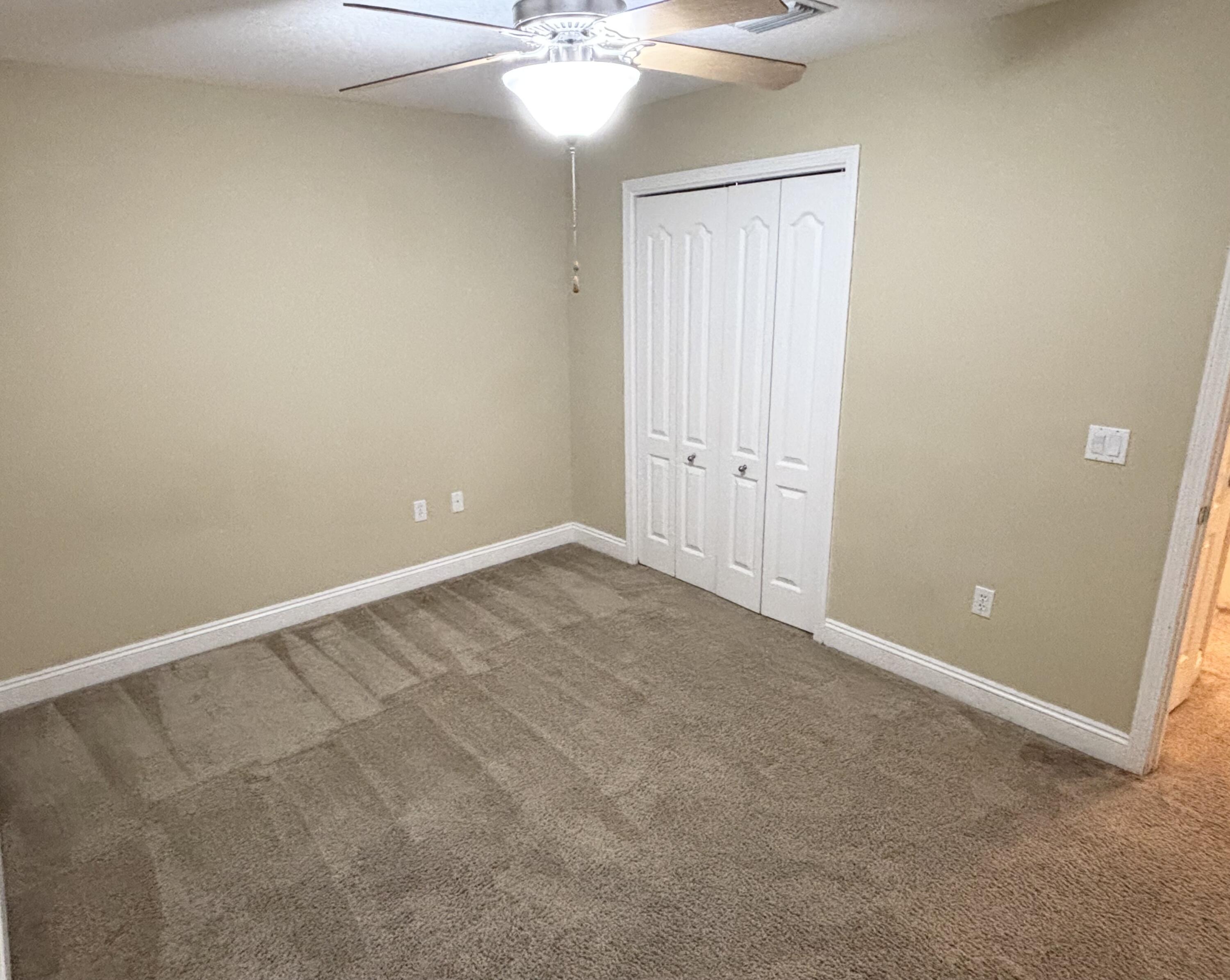 9561 Pouder Lane Navarre, FL 32566 - Photo 17 of 20 a view of an empty room with a chandelier fan