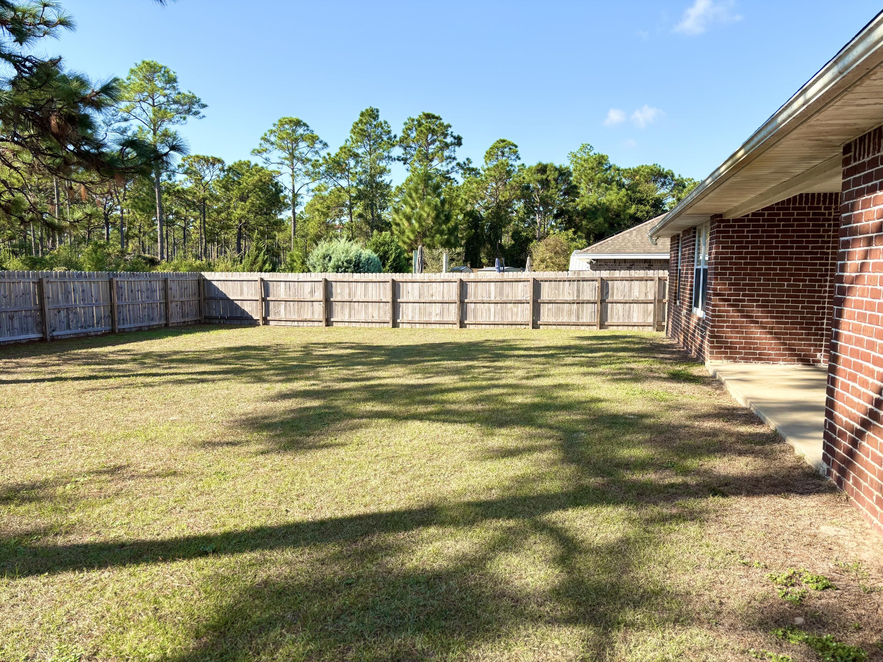 9561 Pouder Lane Navarre, FL 32566 - Photo 18 of 20 a swimming pool with an outdoor space