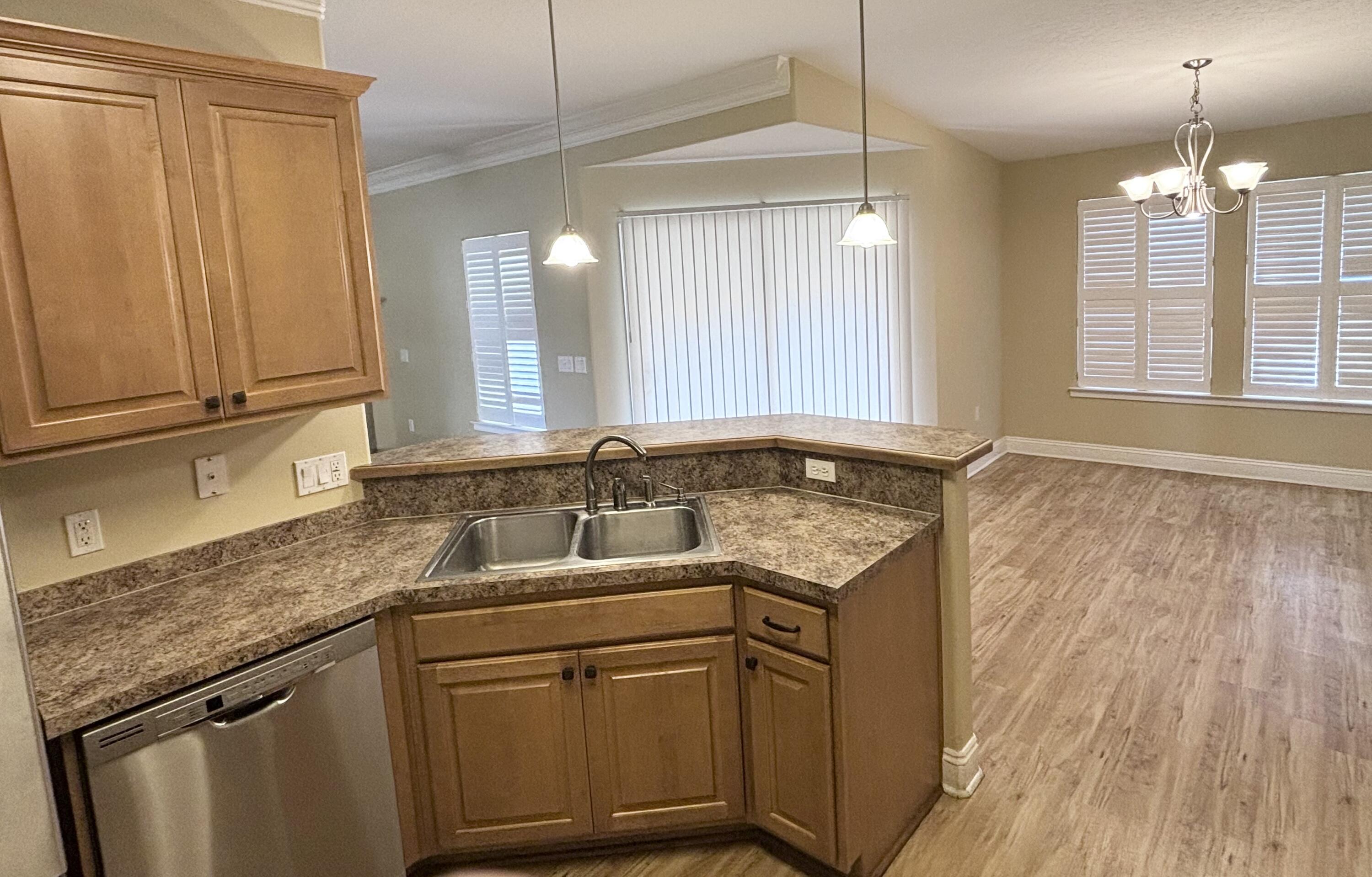 9561 Pouder Lane Navarre, FL 32566 - Photo 5 of 20 a kitchen with granite countertop cabinets stainless steel appliances a sink and wooden floor
