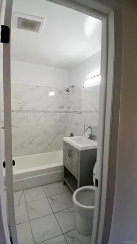 a bathroom with a bathtub sink and toilet