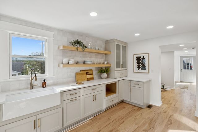 a kitchen with cabinets a sink and appliances