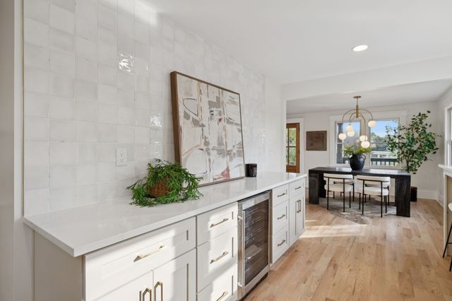 a kitchen with white cabinets and white appliances