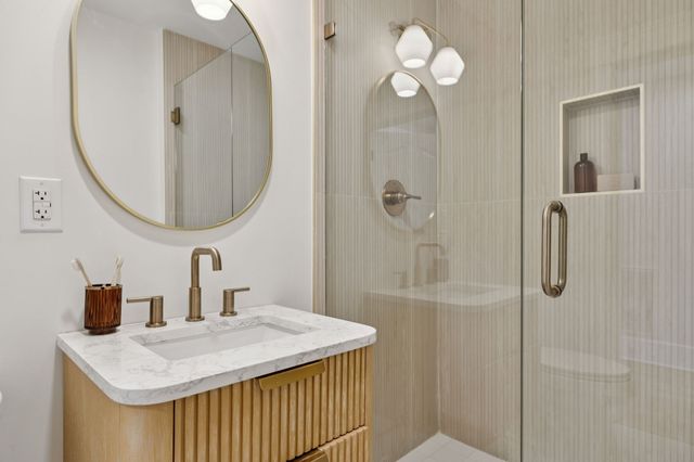a bathroom with a sink vanity and a mirror
