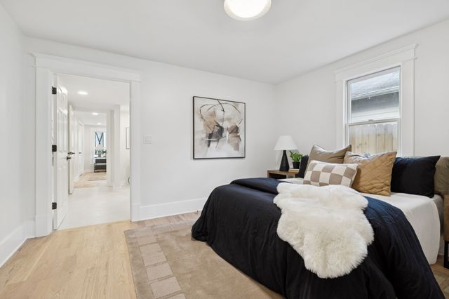 a bedroom with a bed and a painting on the wall