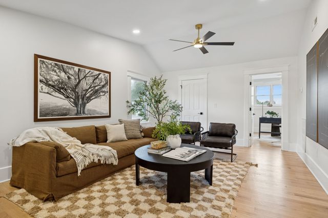 a living room with furniture and a wooden floor