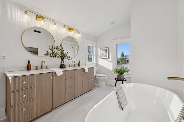 a spacious bathroom with a double vanity sink and a mirror