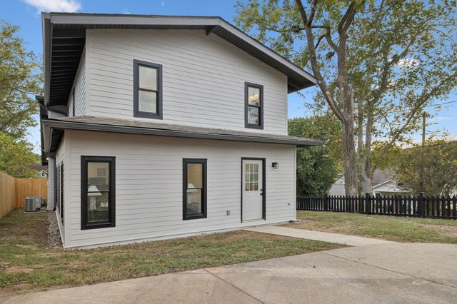 a house that has a tree in front of the house