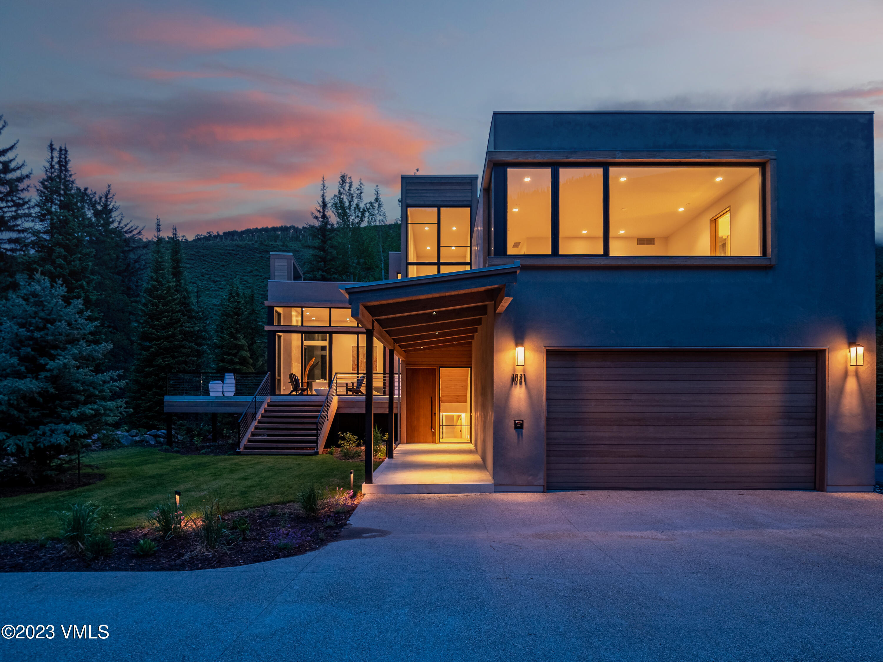 1031 Eagles Nest Circle Vail, CO 81657 - Photo 11 of 12 a front view of a house with a yard and garage