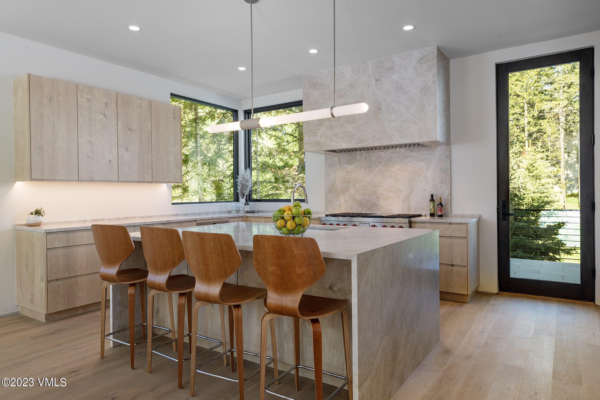 1031 Eagles Nest Circle Vail, CO 81657 - Photo 3 of 12 a kitchen with a table chairs refrigerator and microwave