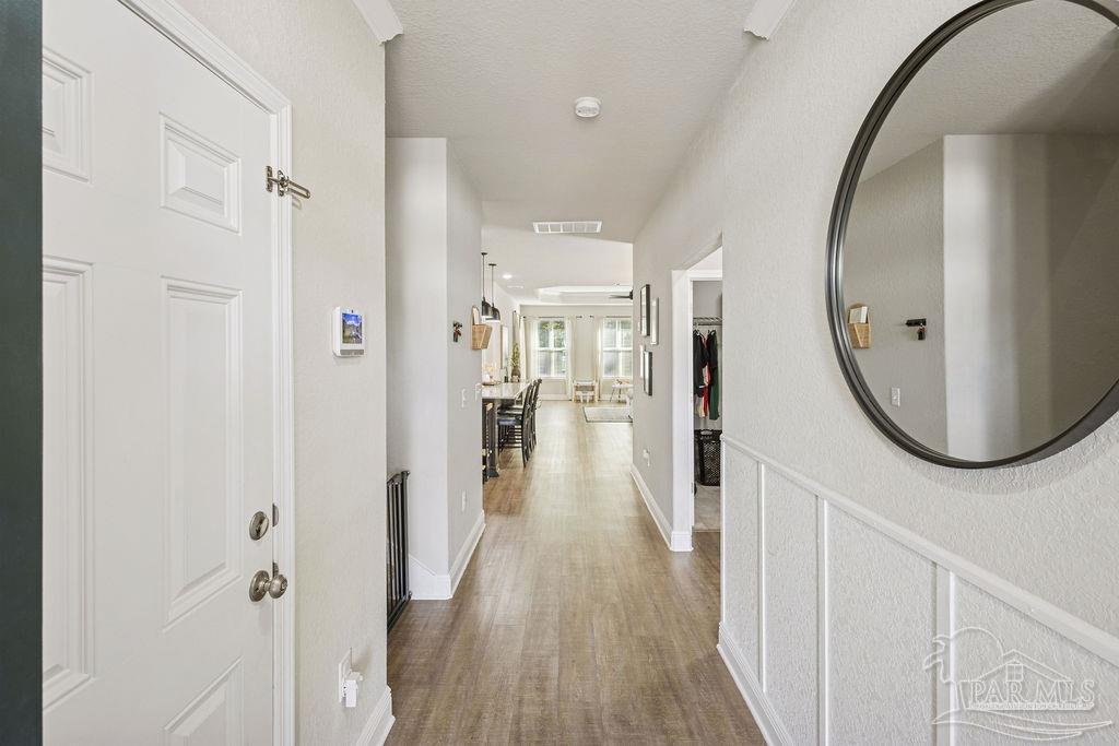 5392 Parkside Drive Pace, FL 32571 - Photo 11 of 28 wooden floor in a gallery with a mirror