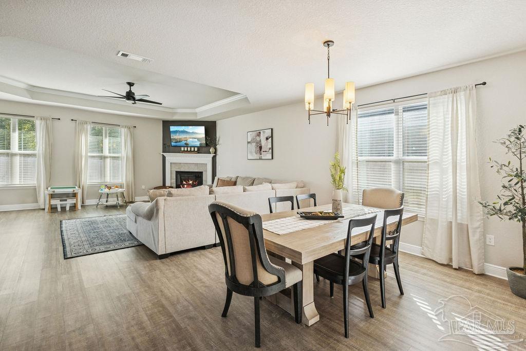 5392 Parkside Drive Pace, FL 32571 - Photo 12 of 28 a view of a dining room with furniture window and wooden floor
