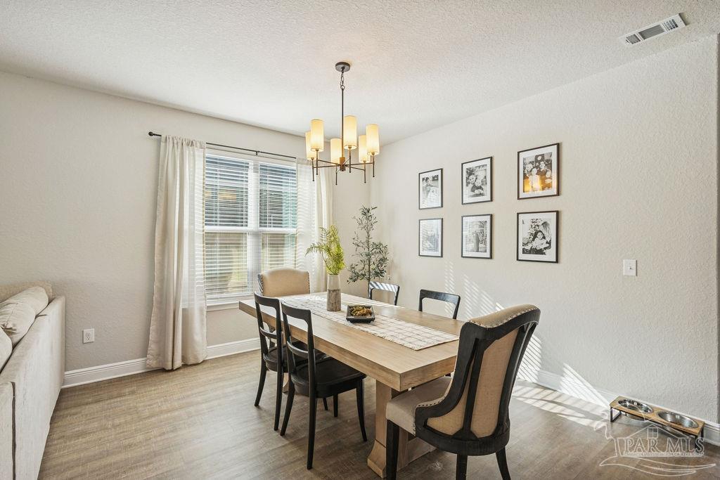 5392 Parkside Drive Pace, FL 32571 - Photo 13 of 28 a view of a dining room with furniture window and wooden floor