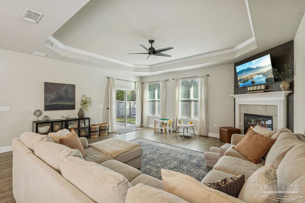 5392 Parkside Drive Pace, FL 32571 - Photo 14 of 28 a living room with furniture a fireplace and a flat screen tv