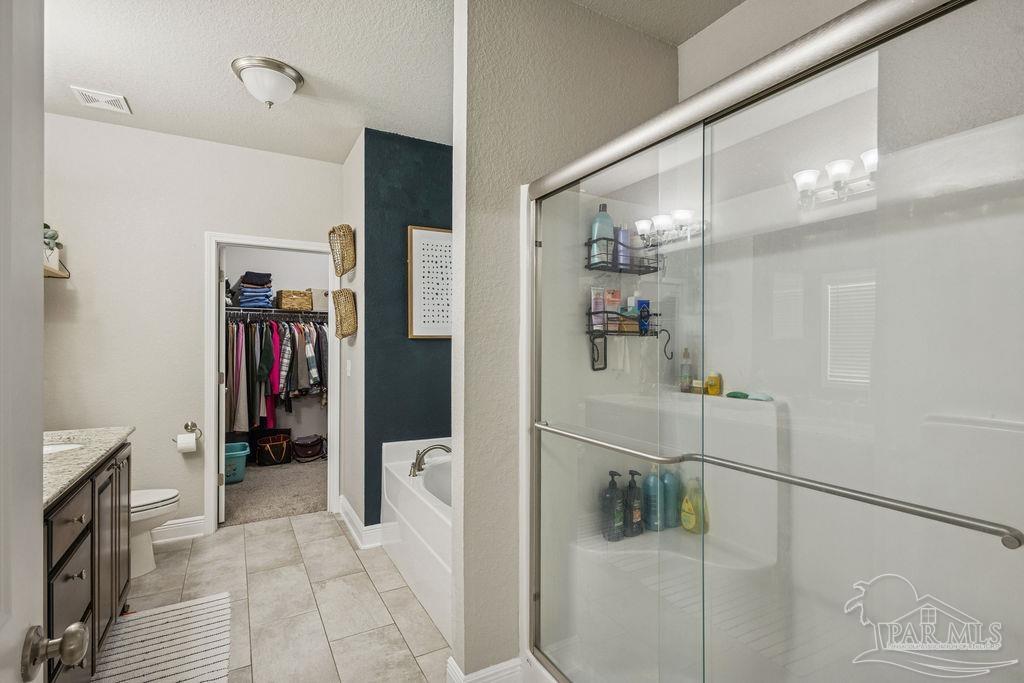 5392 Parkside Drive Pace, FL 32571 - Photo 19 of 28 a hallway with a white stove top oven and a refrigerator
