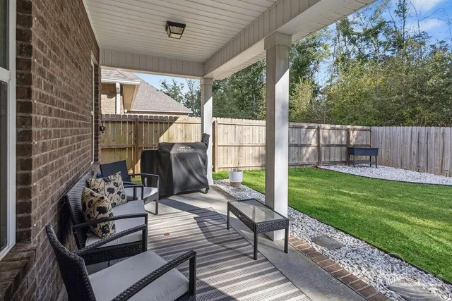 a view of a deck with chair and wooden floor