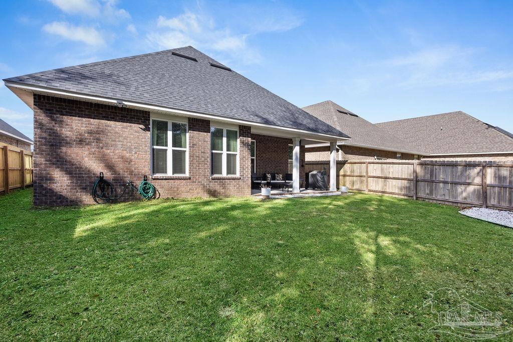 5392 Parkside Drive Pace, FL 32571 - Photo 27 of 28 a view of a house with a yard and sitting area