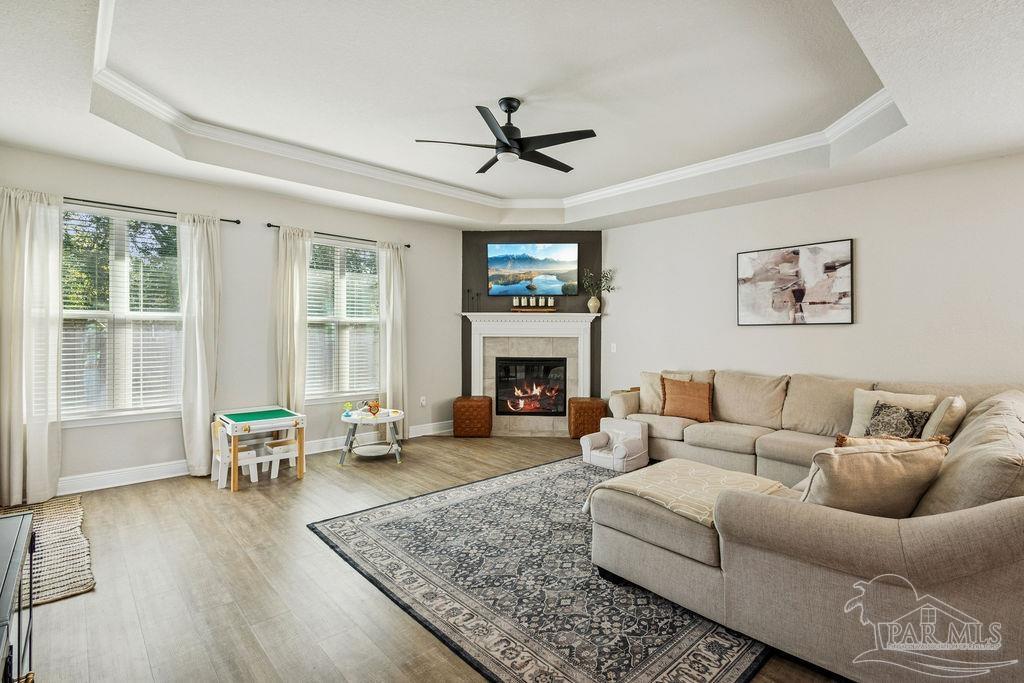 5392 Parkside Drive Pace, FL 32571 - Photo 7 of 28 a living room with furniture large window and a fireplace