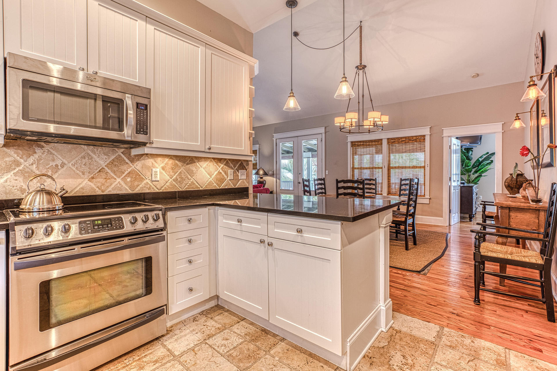 55 Beach Bike Way Seacrest, FL 32461 - Photo 11 of 43 a kitchen with stainless steel appliances granite countertop a stove a sink and a microwave