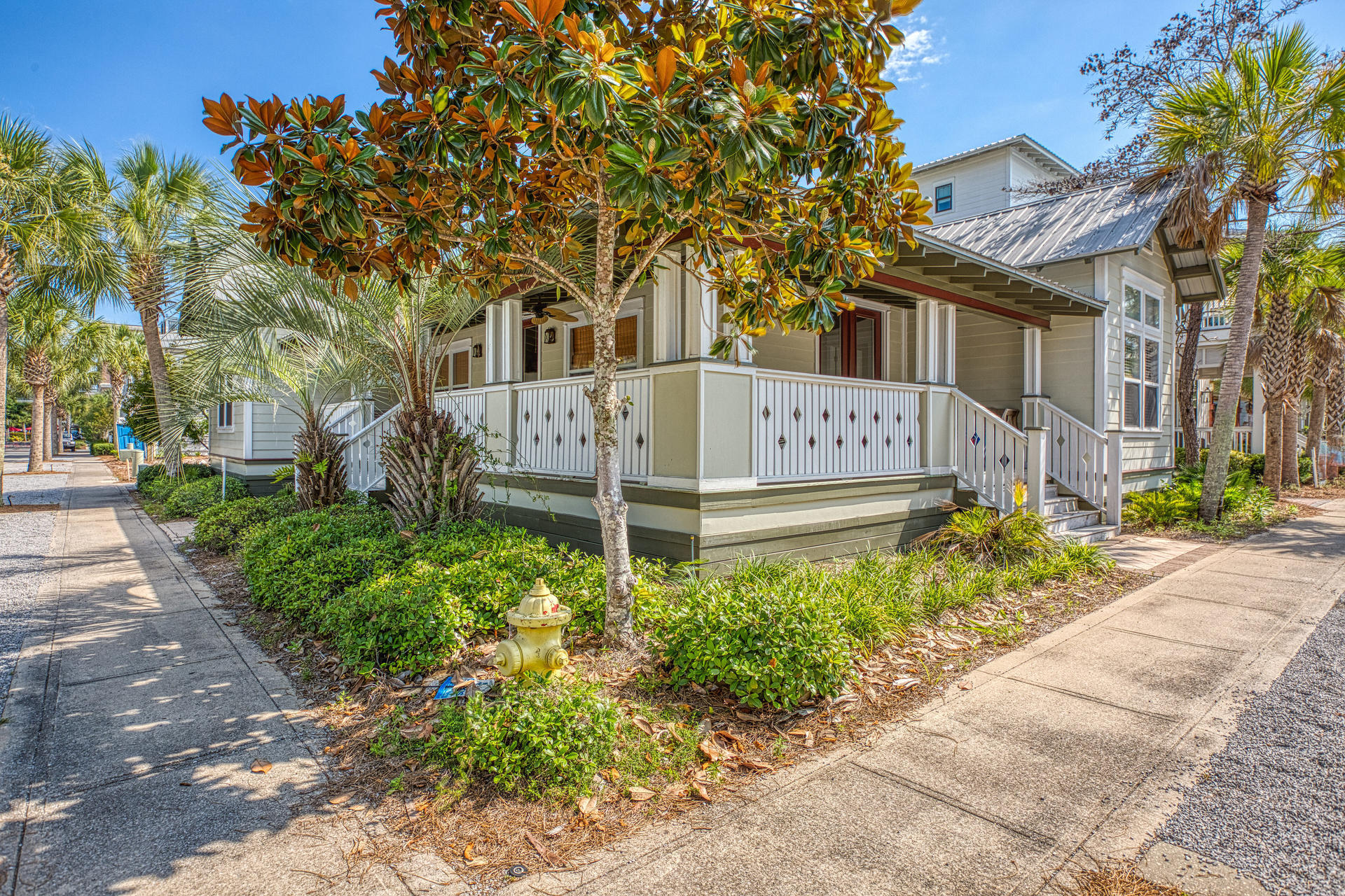 55 Beach Bike Way Seacrest, FL 32461 - Photo 2 of 43 a view of a white house with a small yard and potted plants