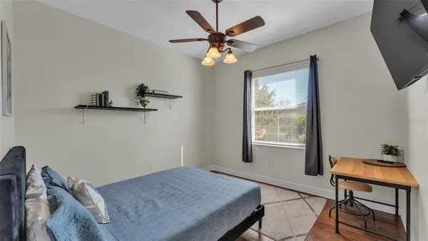 a bedroom with a bed and a flat screen tv