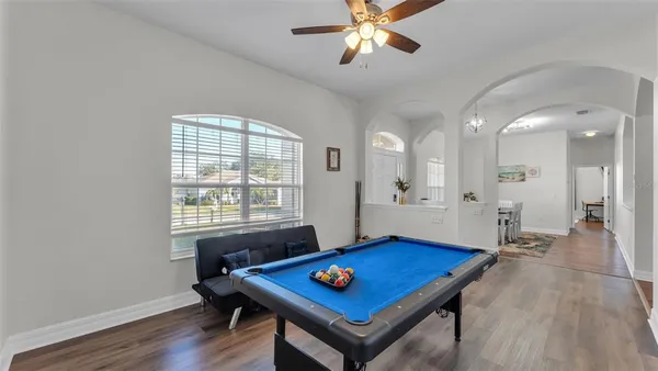 a view of a room with furniture and wooden floor