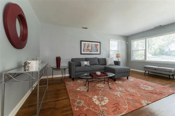 a living room with furniture and a rug