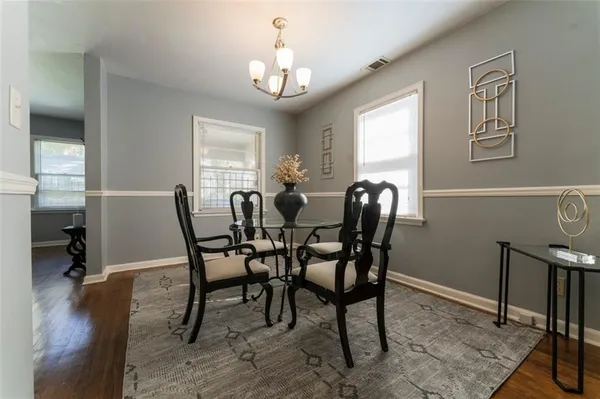 a view of a dining room with furniture and wooden floor