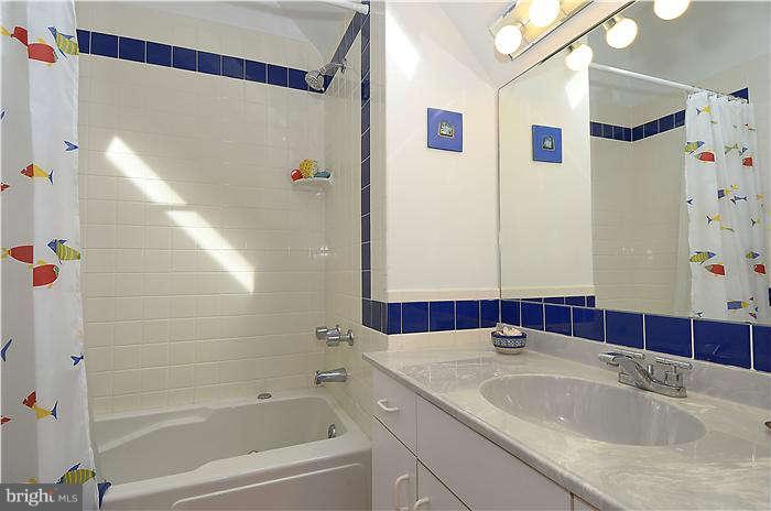 1201 Rogers Road Edgewater, MD 21037 - Photo 23 of 30 a bathroom with a granite countertop sink and a bathtub