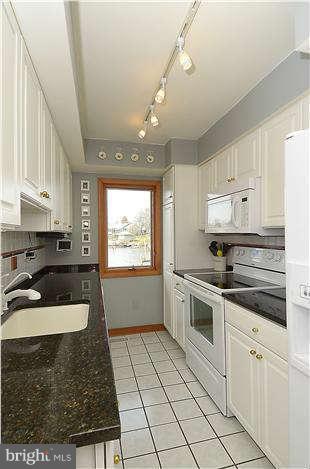 1201 Rogers Road Edgewater, MD 21037 - Photo 9 of 30 a kitchen with a stove a sink and cabinets