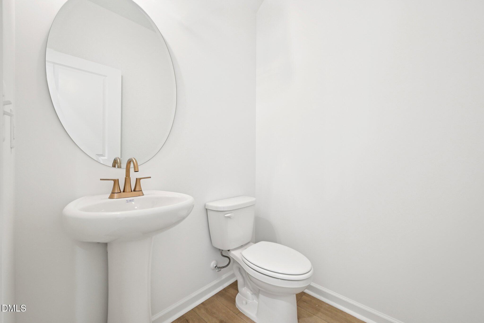 916 Fetching Place, Unit 344 Rolesville, NC 27571 - Photo 14 of 37 a bathroom with a sink toilet and a mirror
