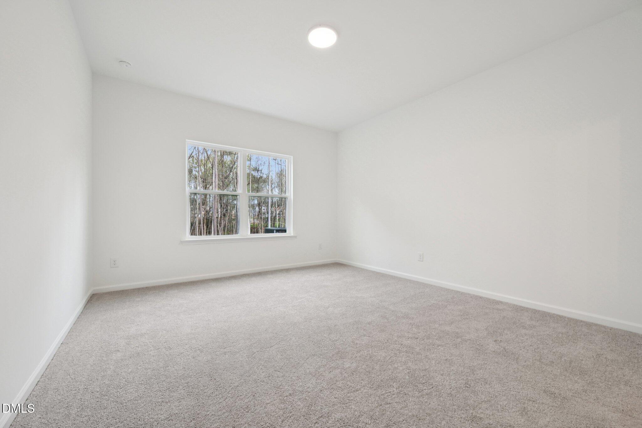 916 Fetching Place, Unit 344 Rolesville, NC 27571 - Photo 15 of 37 an empty room with windows