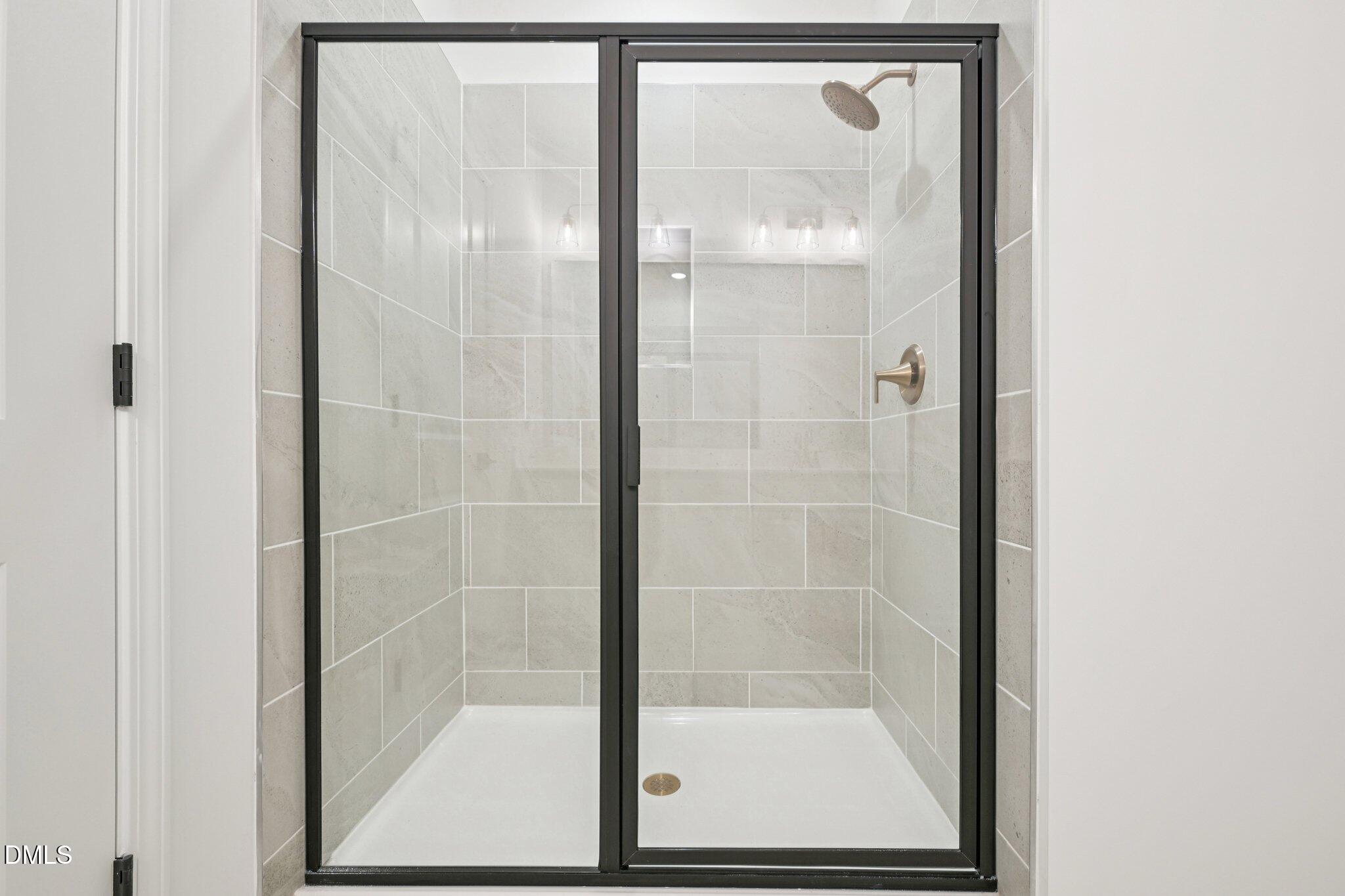 916 Fetching Place, Unit 344 Rolesville, NC 27571 - Photo 18 of 37 a bathroom with a glass shower door