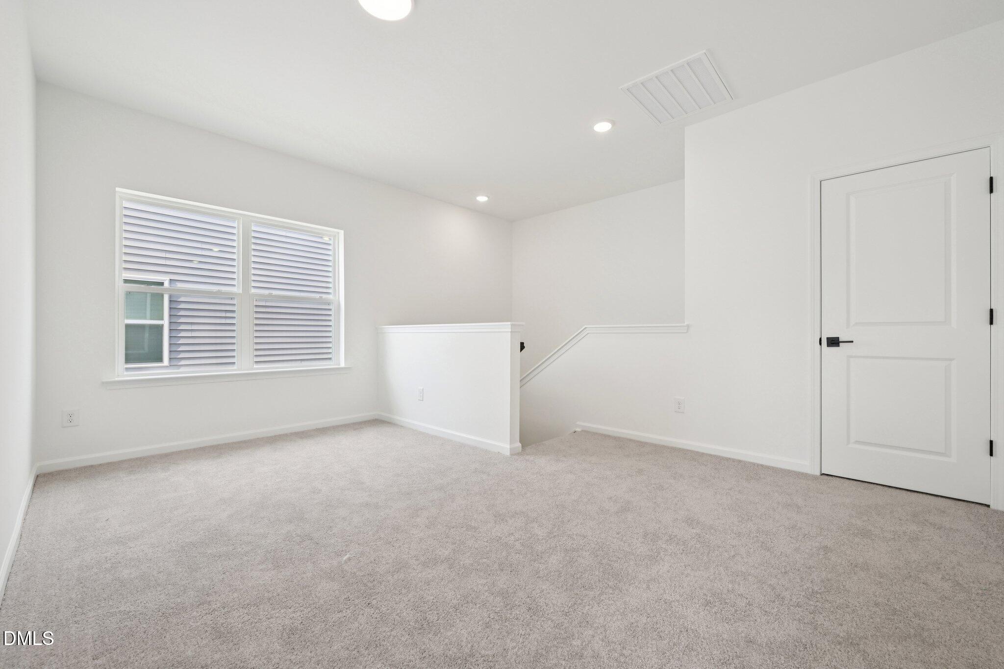 916 Fetching Place, Unit 344 Rolesville, NC 27571 - Photo 20 of 37 a view of an empty room with a window