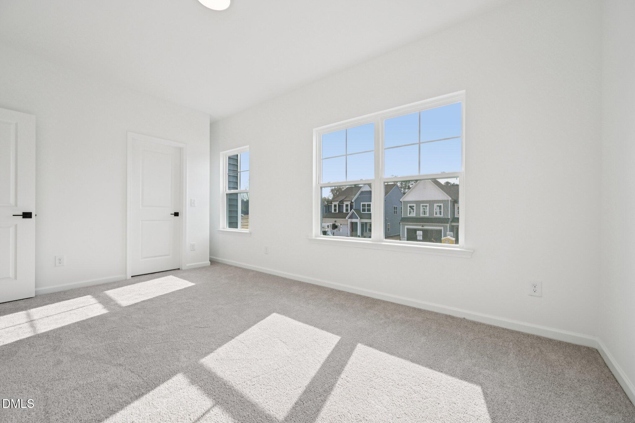 916 Fetching Place, Unit 344 Rolesville, NC 27571 - Photo 22 of 37 an empty room with windows