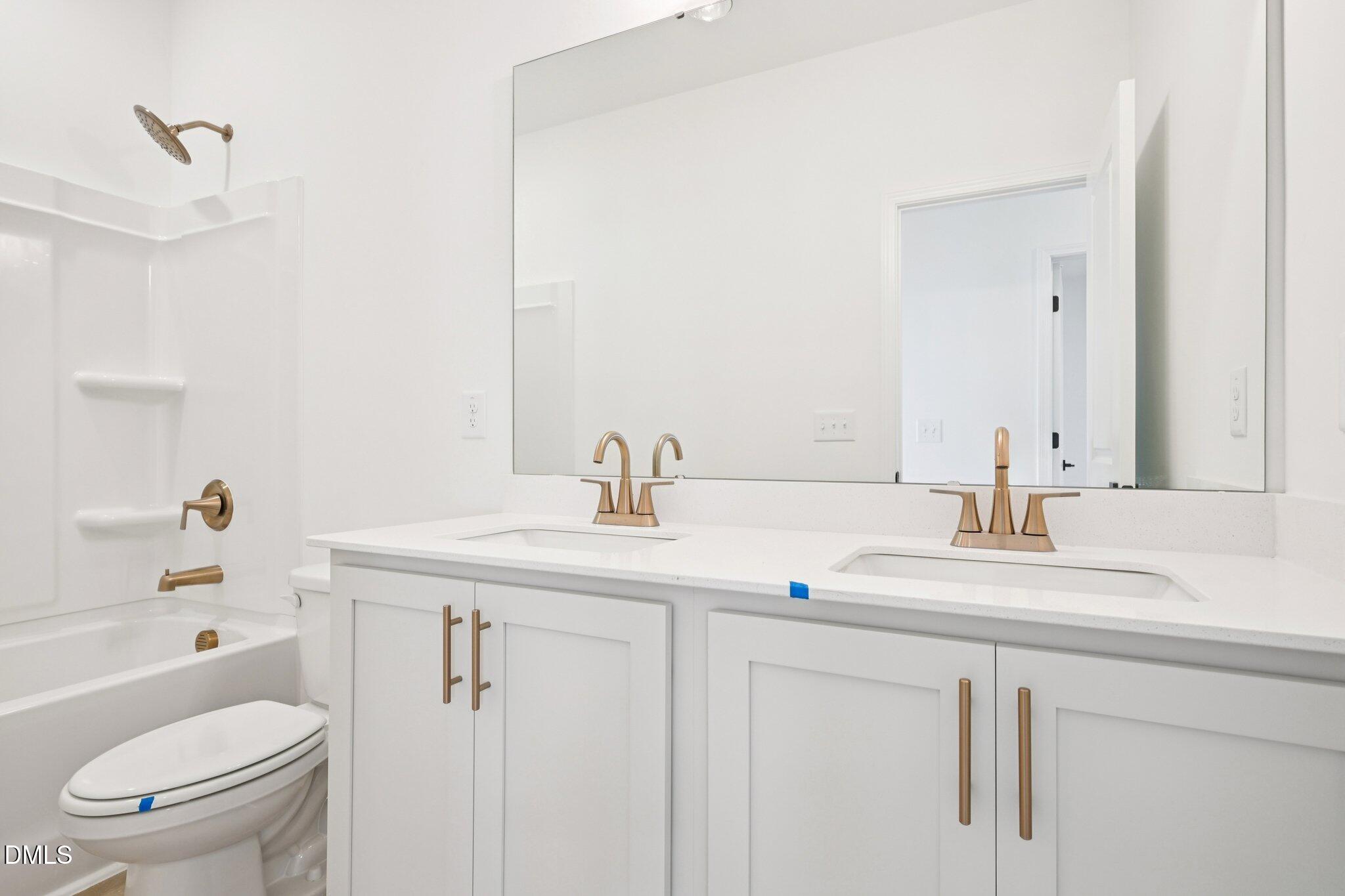 916 Fetching Place, Unit 344 Rolesville, NC 27571 - Photo 23 of 37 a bathroom with a sink toilet vanity and tub